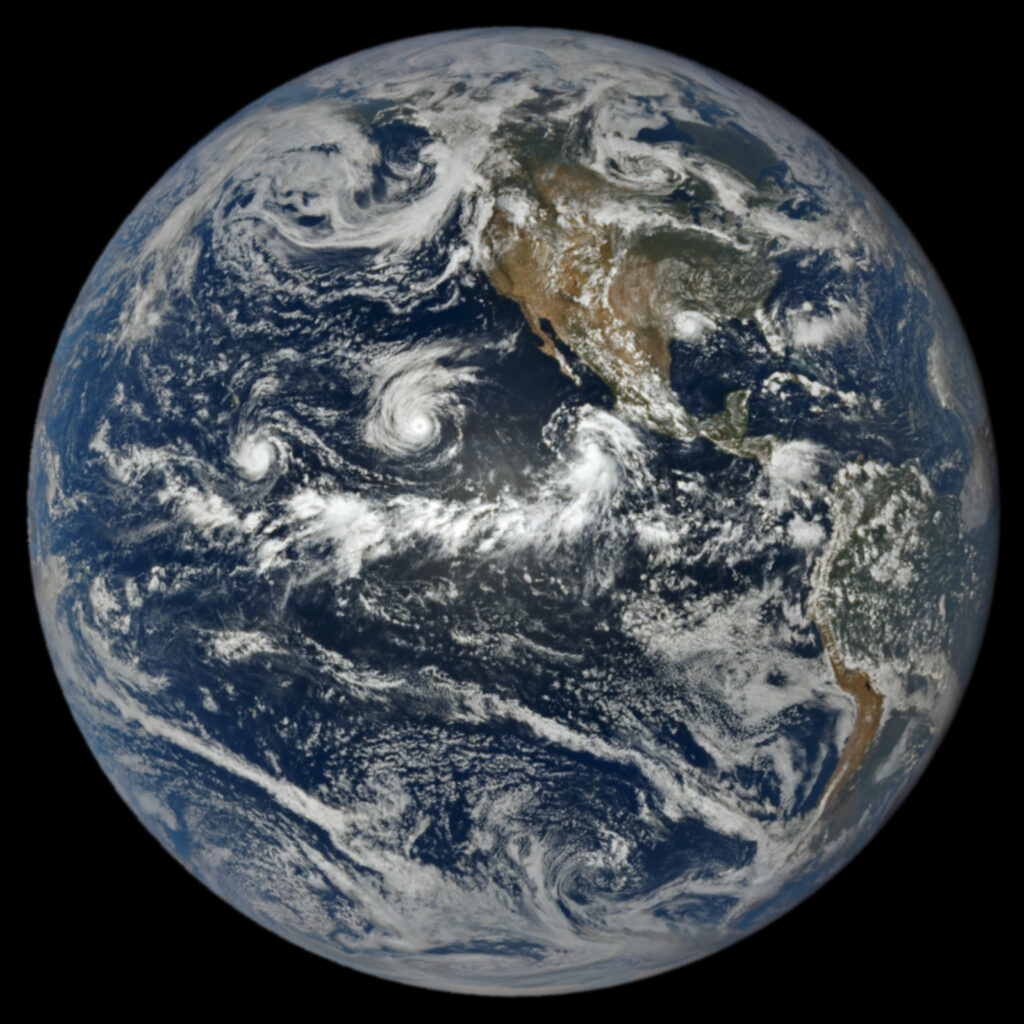 Satellite imagery of the Earth showing three tropical storms in the Pacific west of the United States and Mexico.